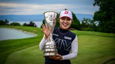 Ayaka Furue holds the Evian Championship trophy in 2024 while waving and smiling