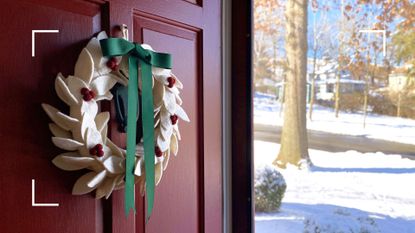 Wreath hanging on a front door, wide open with view of snow-covered street, representing how to handle your family this Christmas