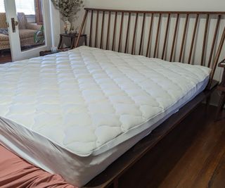 Wide angle of Helix Plush Mattress Topper on a bed.