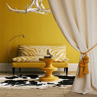 yellow living room with zebra print sofa