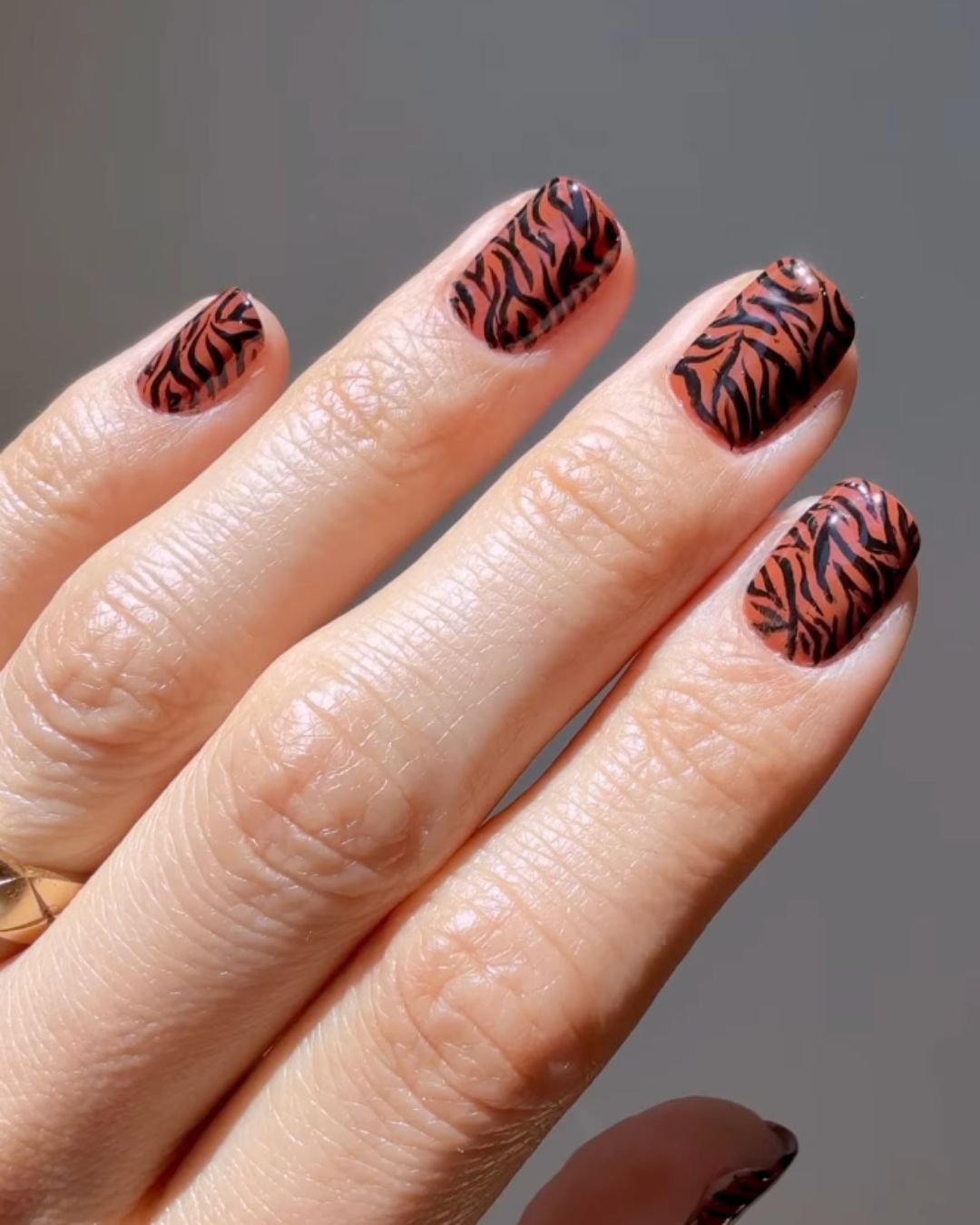 Warm tiger print nails.