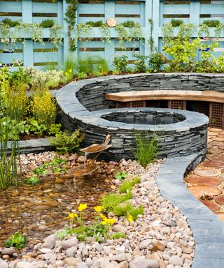 curved slate wall with integrated bench and water feature