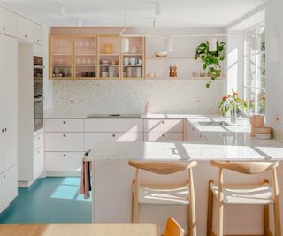 pink kitchen with blue floor, terrazzo worktops and splashback