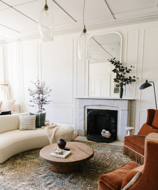 A living room with a fireplace and a white sofa