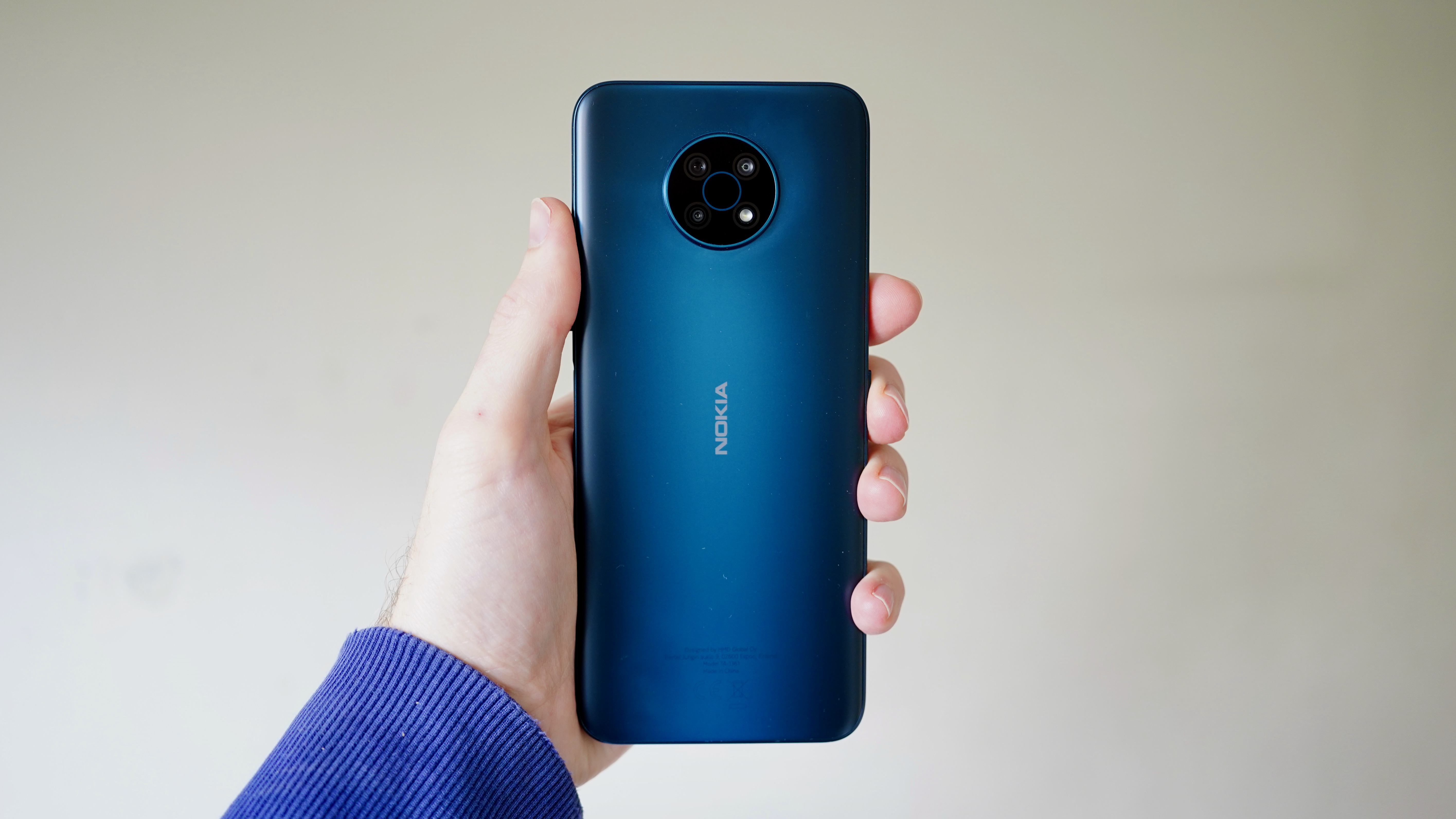 A photo of the Nokia G50 in blue, held in someone's hand