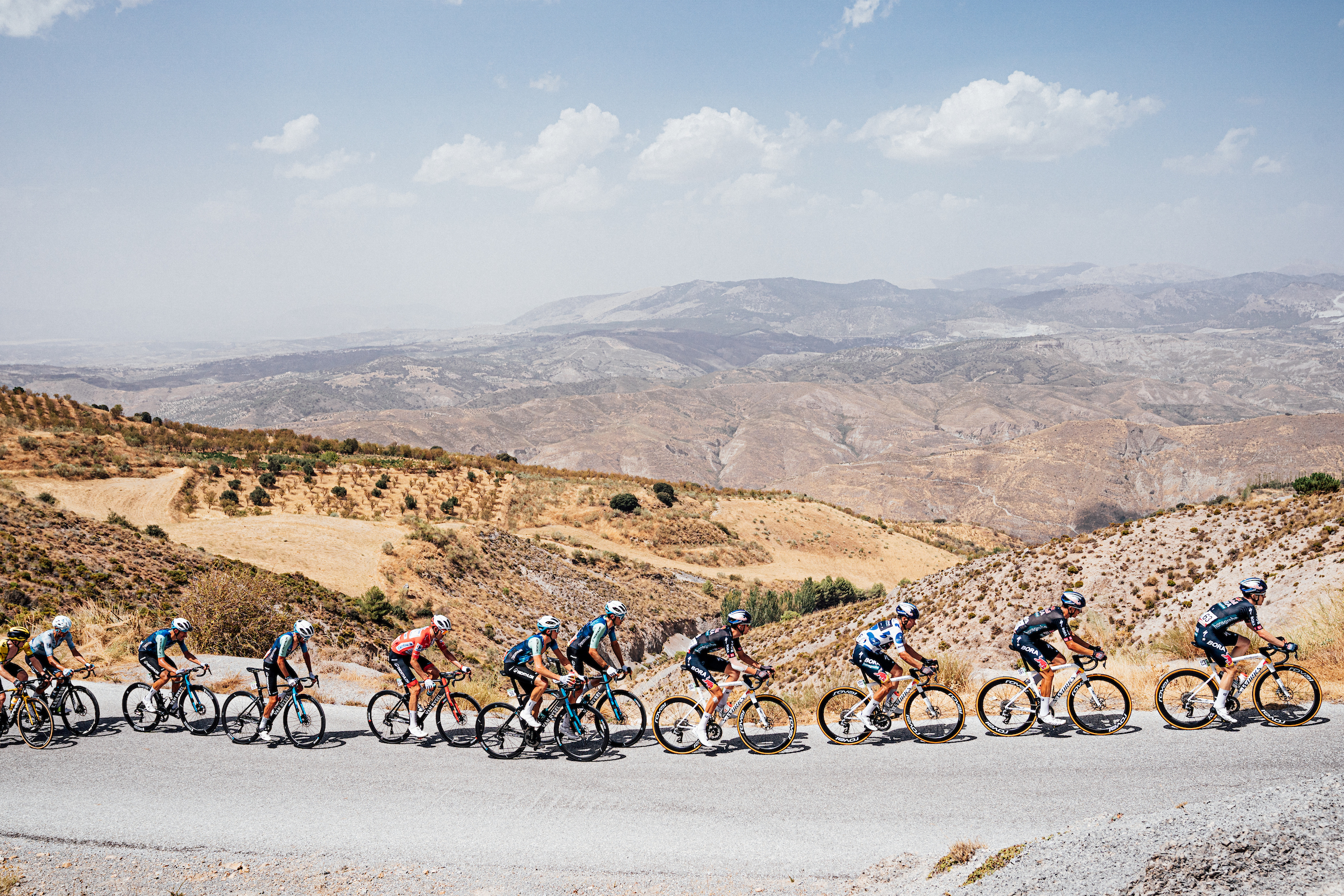 Picture by Zac Williams/SWpix.com - 25/08/2024 - Cycling - 2024 La Vuelta - Stage 9 - Motril - Granada, Spain - The peloton on the first climb of the day.