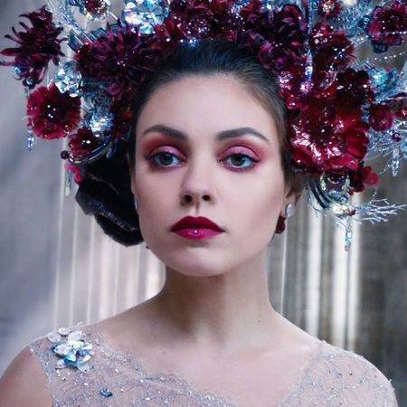 mila kunis in red makeup with a giant flower crown in a still from the movie jupiter ascending