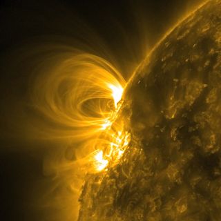 Magnetic field lines arc high above the surface of the sun in this image obtained Feb. 23-27, 2011, by the Solar Dynamics Laboratory. In extreme ultraviolet light the multitude of lines are revealed because charged particles are spinning along them.