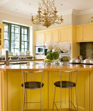 Yellow kitchen with chandelier