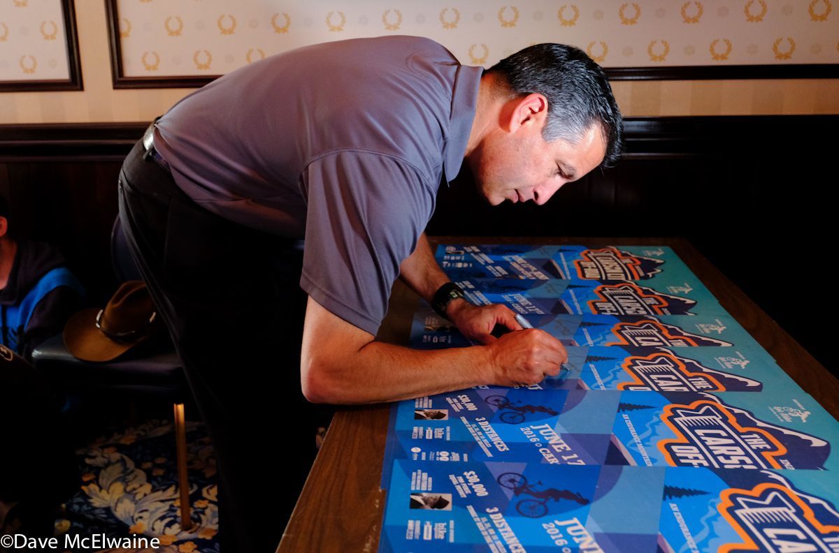 Nevada Governor Brian Sandoval signing race posters at the pro riders meeting held at his official residence.