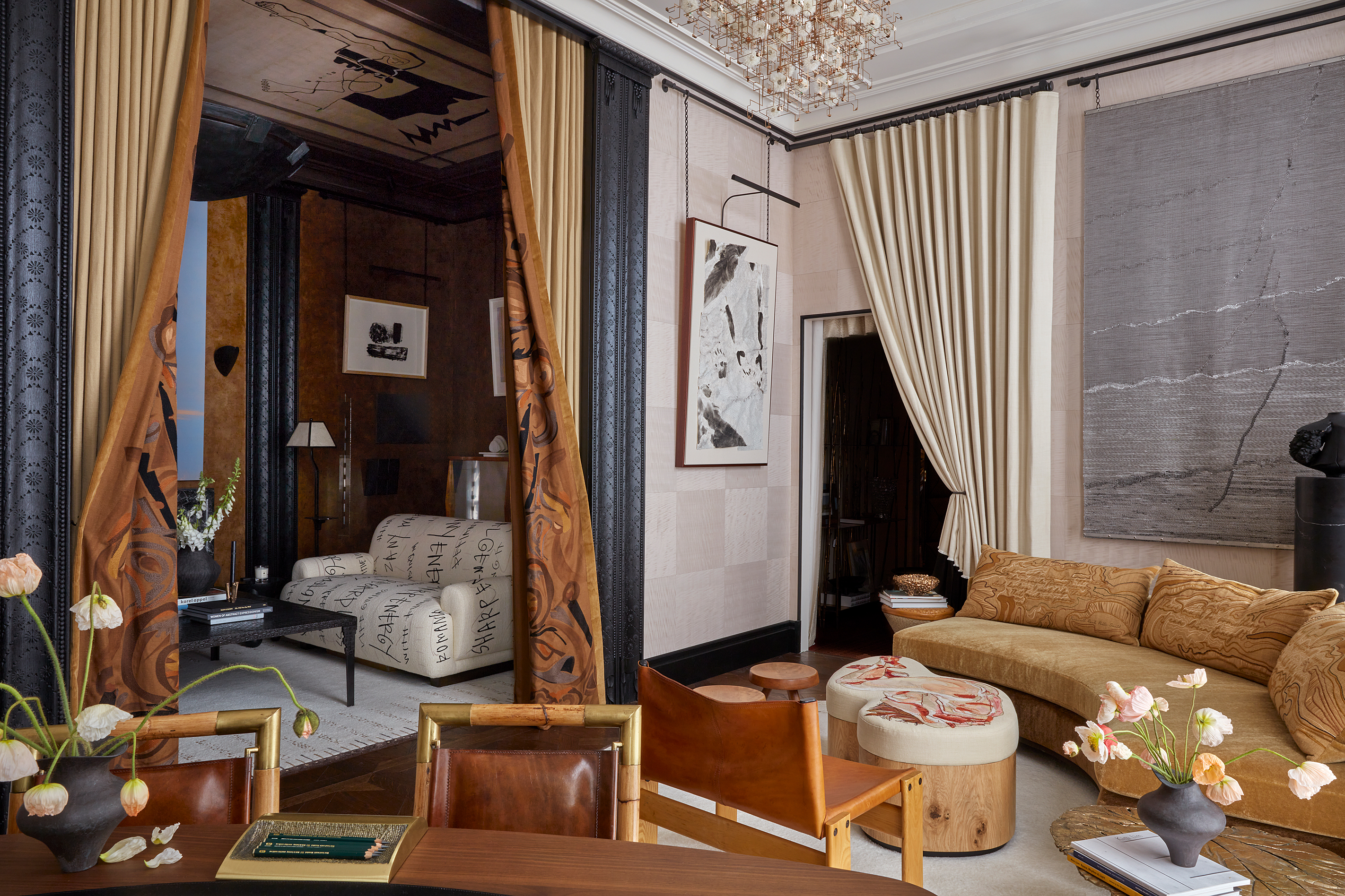 a series of rooms decorated lavishly with large curtains dividing the space