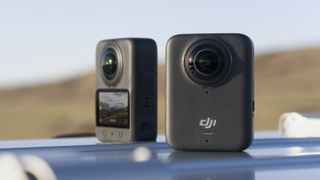 Two DJI Osmo 360 cameras on a car roof, front and back view