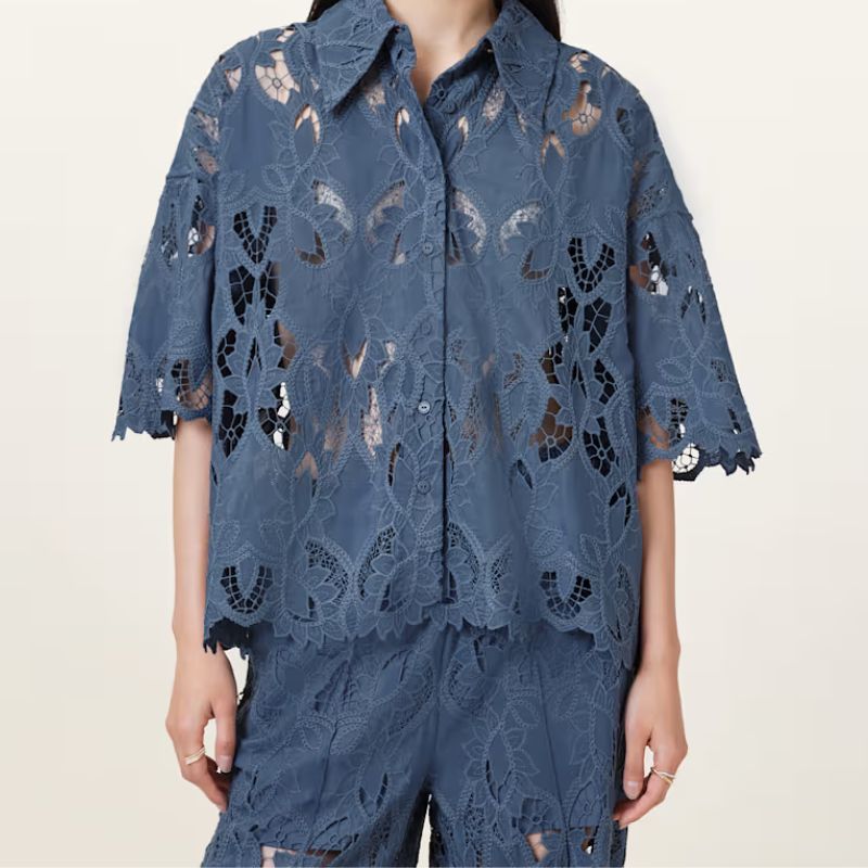 A model wears a dark blue lace blouse