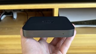 Sky Stream box held in the hand showing how small it is