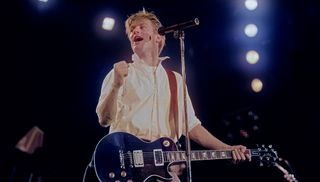 Canadian singer-songwriter Bryan Adams performing on Tina Turner's Private Dancer Tour, on one of four nights at Wembley Arena, London, 14th-17th March 1985. 