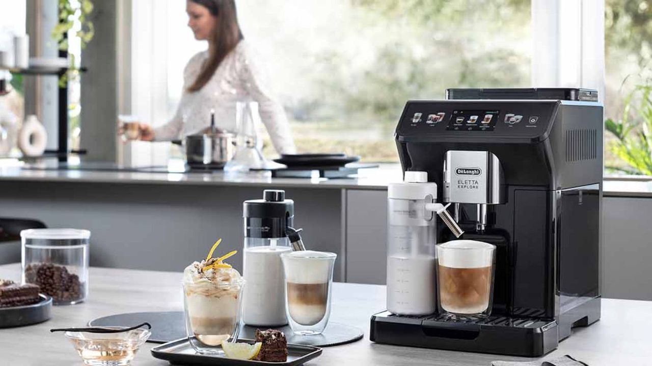 De&#039;Longhi Eletta Explore on the countertop with different types of coffee around it