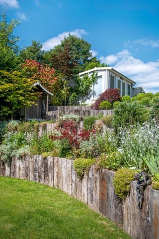 tiered garden ideas: wooden edging alongside levelled flowerbeds