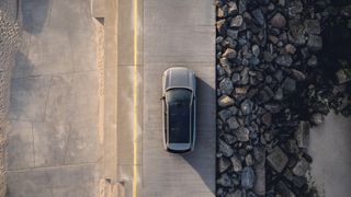 Volvo from above on concrete surface beside rocks