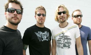 Nickelback posing for a photograph backstage at a gig in 2005