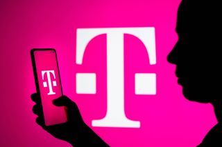Woman holding phone with T-Mobile logo against pink background with T-Mobile logo