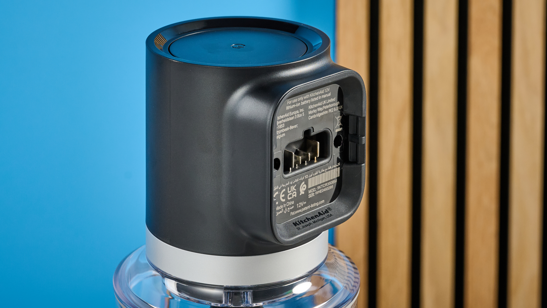 KitchenAid Cordless Top Down Food Chopper photographed in front of a blue background.