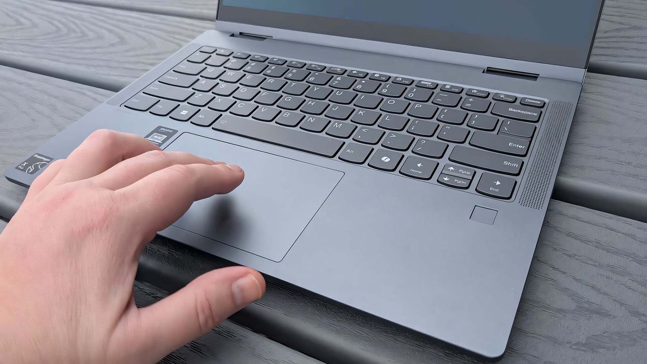 A hand on the Lenovo IdeaPad 5x 2-in-1's touchpad.