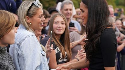 Meghan, Duchess of Sussex chats with well-wishers on the Long walk at Windsor Castle on September 10, 2022, two days after the death of Britain's Queen Elizabeth II at the age of 96. - King Charles III pledged to follow his mother's example of "lifelong service" in his inaugural address to Britain and the Commonwealth on Friday, after ascending to the throne following the death of Queen Elizabeth II on September 8.