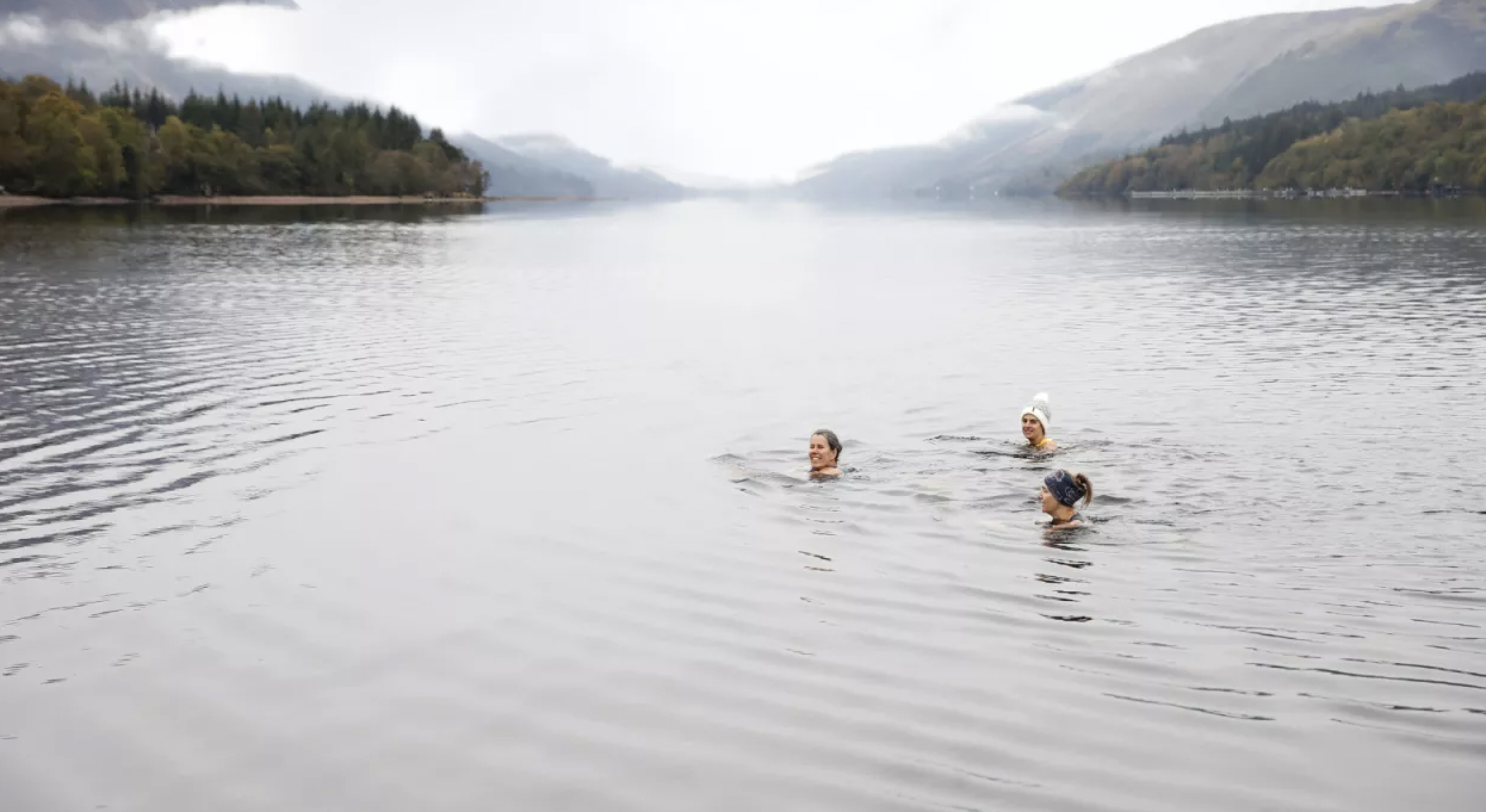 Women wild swimming in a lake