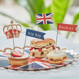 Scones with jam and cream with British cake toppers