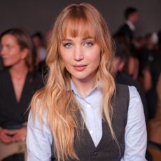 Jennifer Lawrence at a fashion show in Paris with warm blonde hair