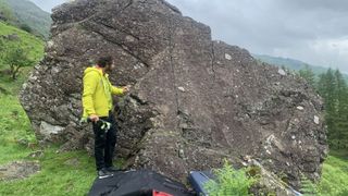 A bouldering instructor explains a problem on the rock