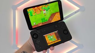 Hand holding Ayaneo Flip DS handheld with Zelda: A Link Between Worlds on screen and Nanoleaf Lines lighting in backdrop