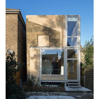 Exterior of house with glass door and wooden wall