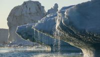 melting ice pours off the tip of an ice sheet