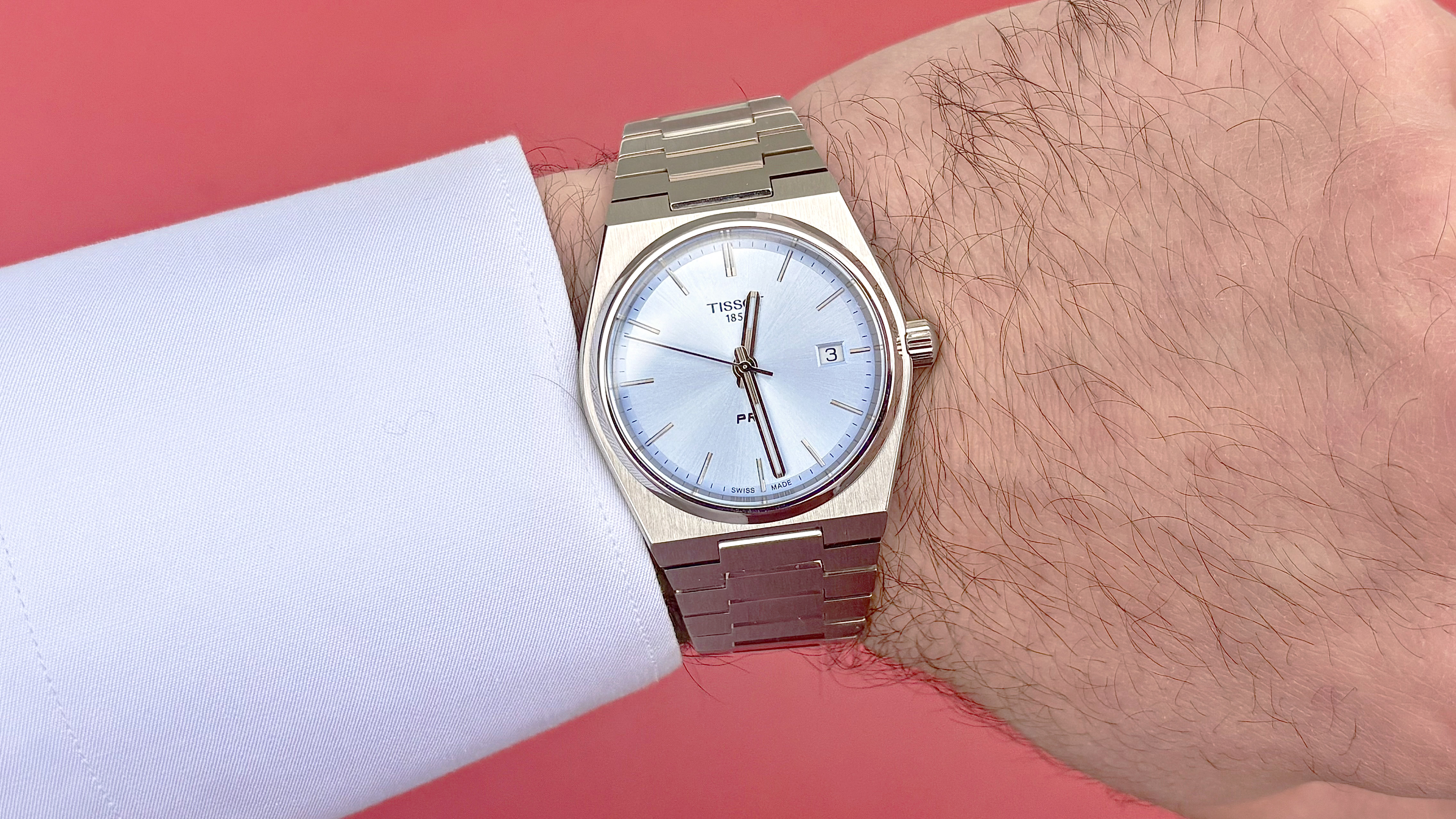 Close-up of a Tissot PRX quartz watch on writer, Dan Bracaglia's, wrist