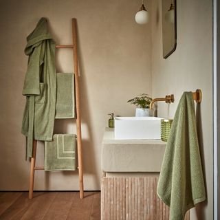 Neutral bathroom with green textiles