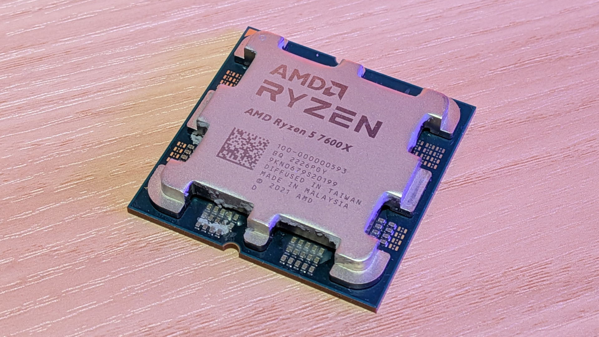 A stylized photo of an AMD Ryzen 5 7600X processor.