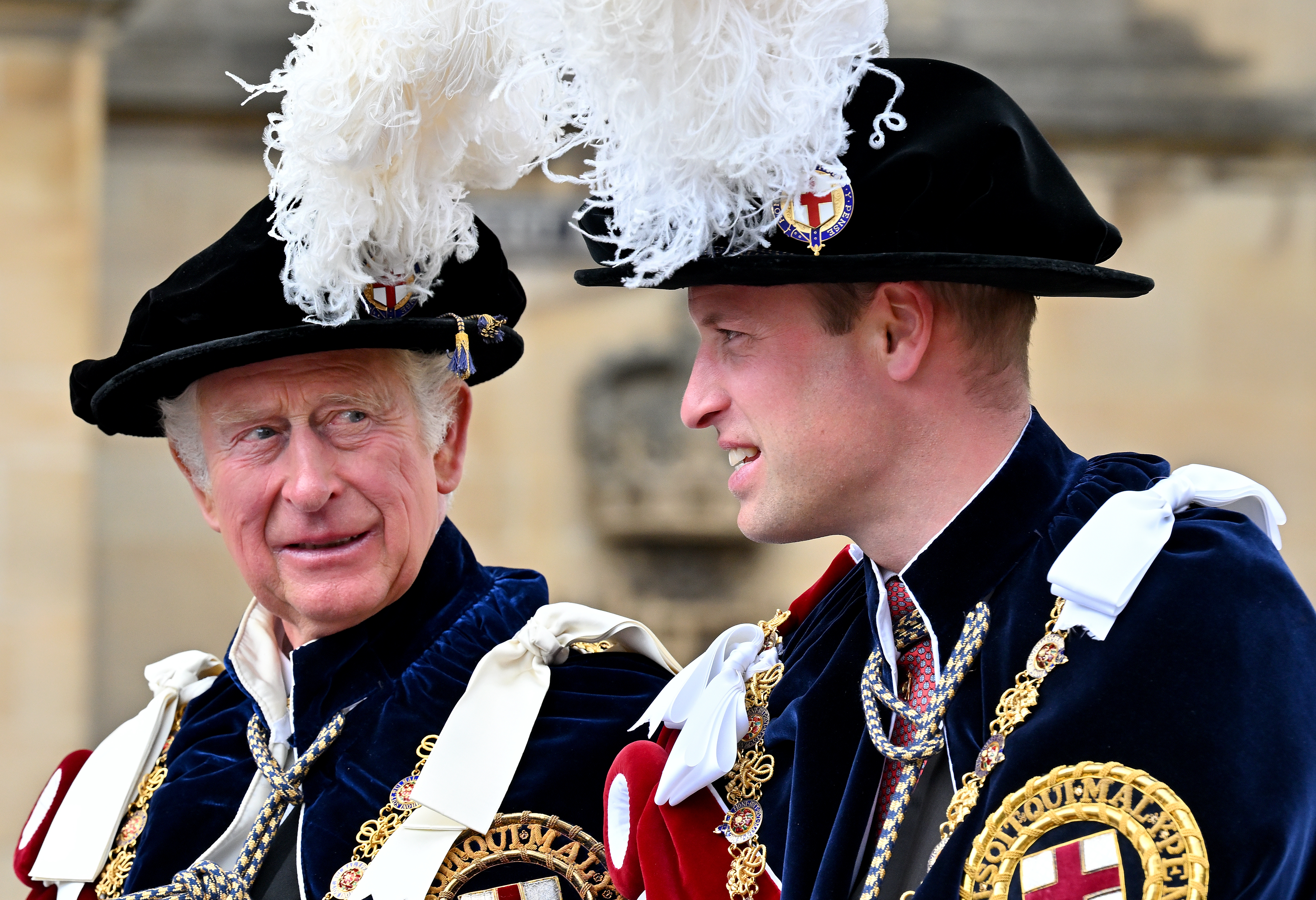 King Charles and Prince William wearing feathered hats and velvet robes at Garter Day