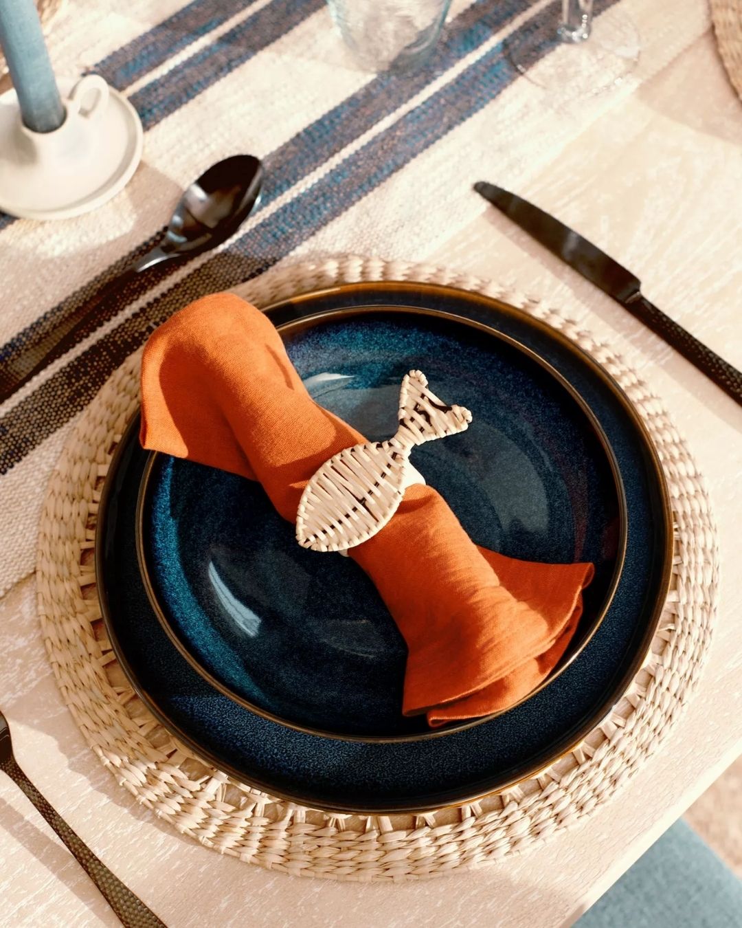 A series of sculptural rattan decorative items, including place mats, cake stands, laundry baskets, lights, napkin rings, and storage units.