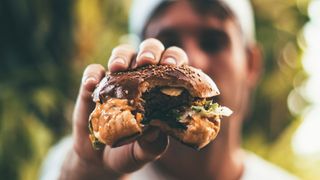 person holding hamburger