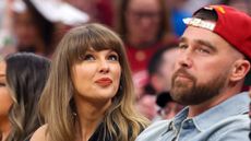Taylor Swift and Travis Kelce attend a sports event
