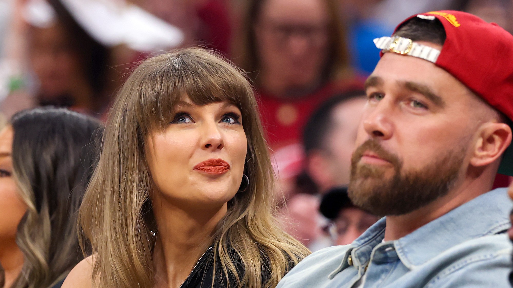 Taylor Swift and Travis Kelce attend a sports event