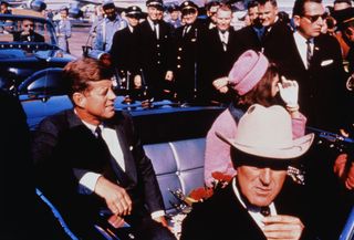 President John F. Kennedy and his wife Jacqueline in a limousine in Dallas shortly before his assassination on Nov. 22, 1963. (Texas Gov. John Connally adjusts his tie in the foreground.)