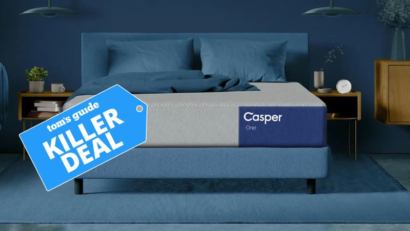 The image shows the Casper One mattress on a blue bed foundation in a blue bedroom