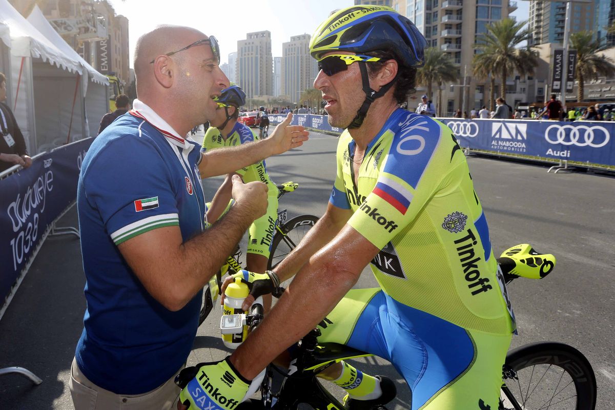Paolo Bettini chats with his former teammate Matteo Tosatto.