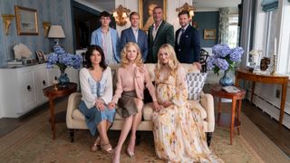 (L to R) Eve Hewson as Amelia Sacks, Sam Nivola as Will Winbury, Nicole Kidman as Greer Winbury, Billy Howle as Benji Winbury, Liev Schreiber as Tag Winbury, Dakota Fanning as Abby Winbury, Jack Reynor as Thomas Winbury seated together in Netflix's "The Perfect Couple" in a plush room