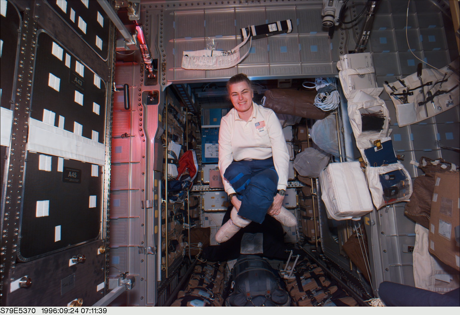 During off-duty time in the Spacehab Module, astronaut Shannon W. Lucid uses the microgravity of space to fabricate her own kind of easy chair as the days of her lengthy Russian Mir Space Station stay as a cosmonaut guest researcher come to a close in September 1996.