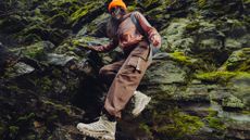 Woman hiking off cliffside