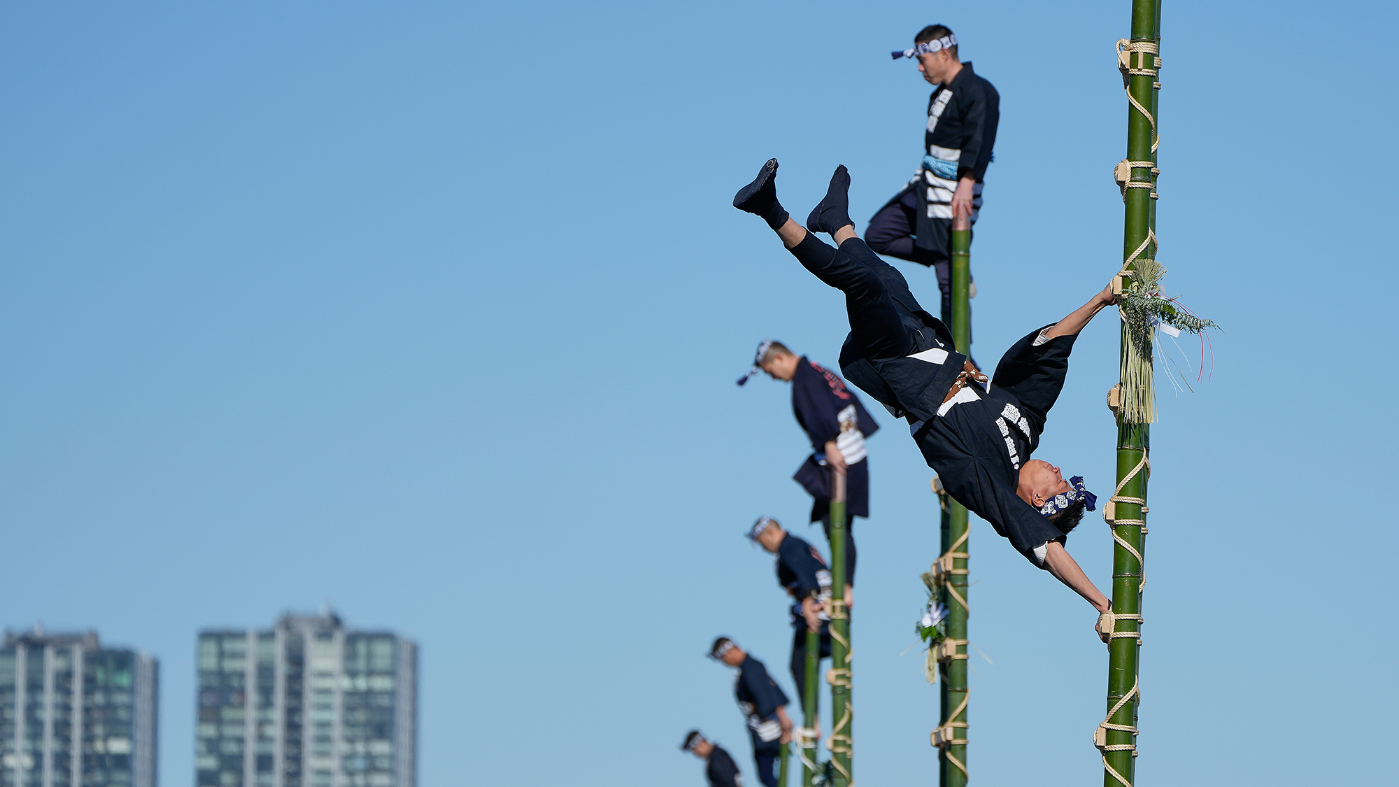 Members of a traditional firefighting preservation group perform ladder stunts during the New Year's Fire Review in Tokyo, Japan