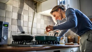 Woman cooking homemade meal in kitchen